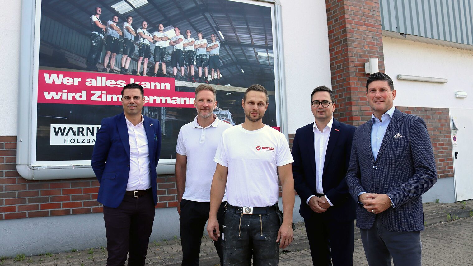 Markus Schrader, Regionaldirektor IKK classic, Christian Suhr, Signal Iduna, Philip Warnke, Jan Göldner, Geschäftsführer der Kreishandwerkerschaft Elbe-Weser, und Torsten Stock, Mewa-Textilsharing, vor dem Plakat
