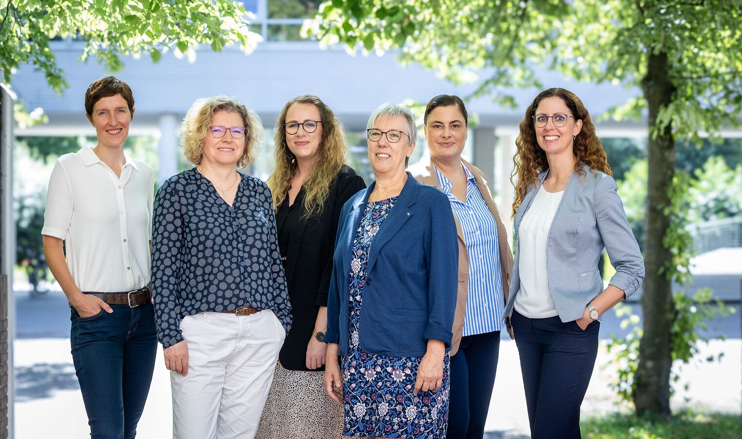 Das Team der Weiterbildungsberatung Nordostniedersachsen stellt sich vor Sechs Frauen des Teams „Wegweiser Weiterbildung Nordostniedersachsen“ im Außenbereich vor grünem Hintergrund